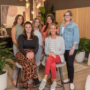 Group of ladies standing together in a furniture store