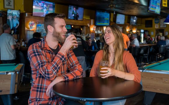 Young couple on a date at The Bull Dog Arm in Downtown Bettendorf, IA.
