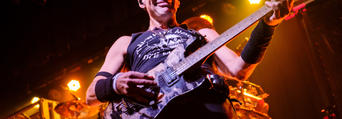 Rock and Roll Guy Playing Electric Guitar with a dark background