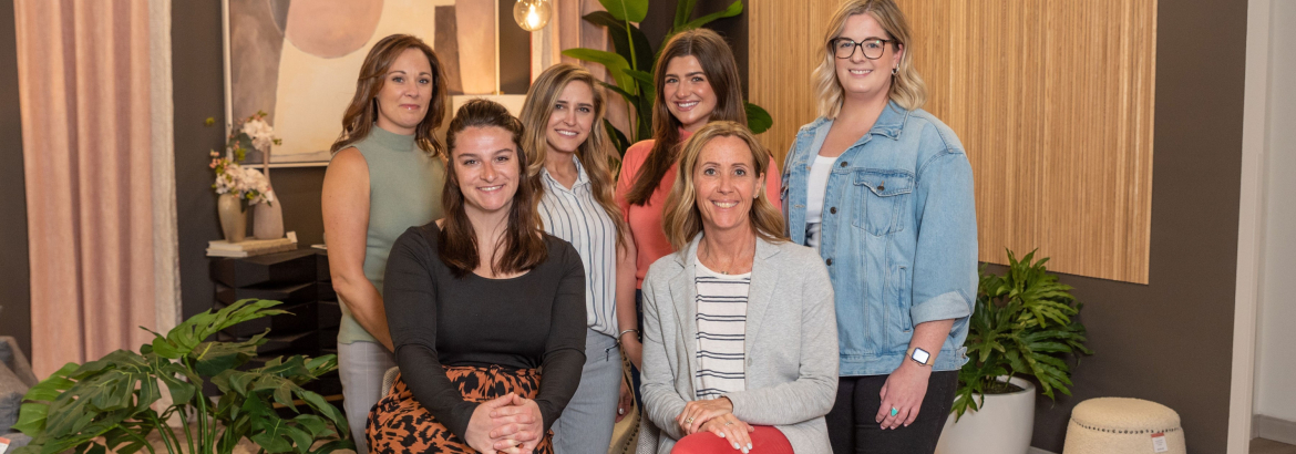 group photo of 6 ladies in a furniture store