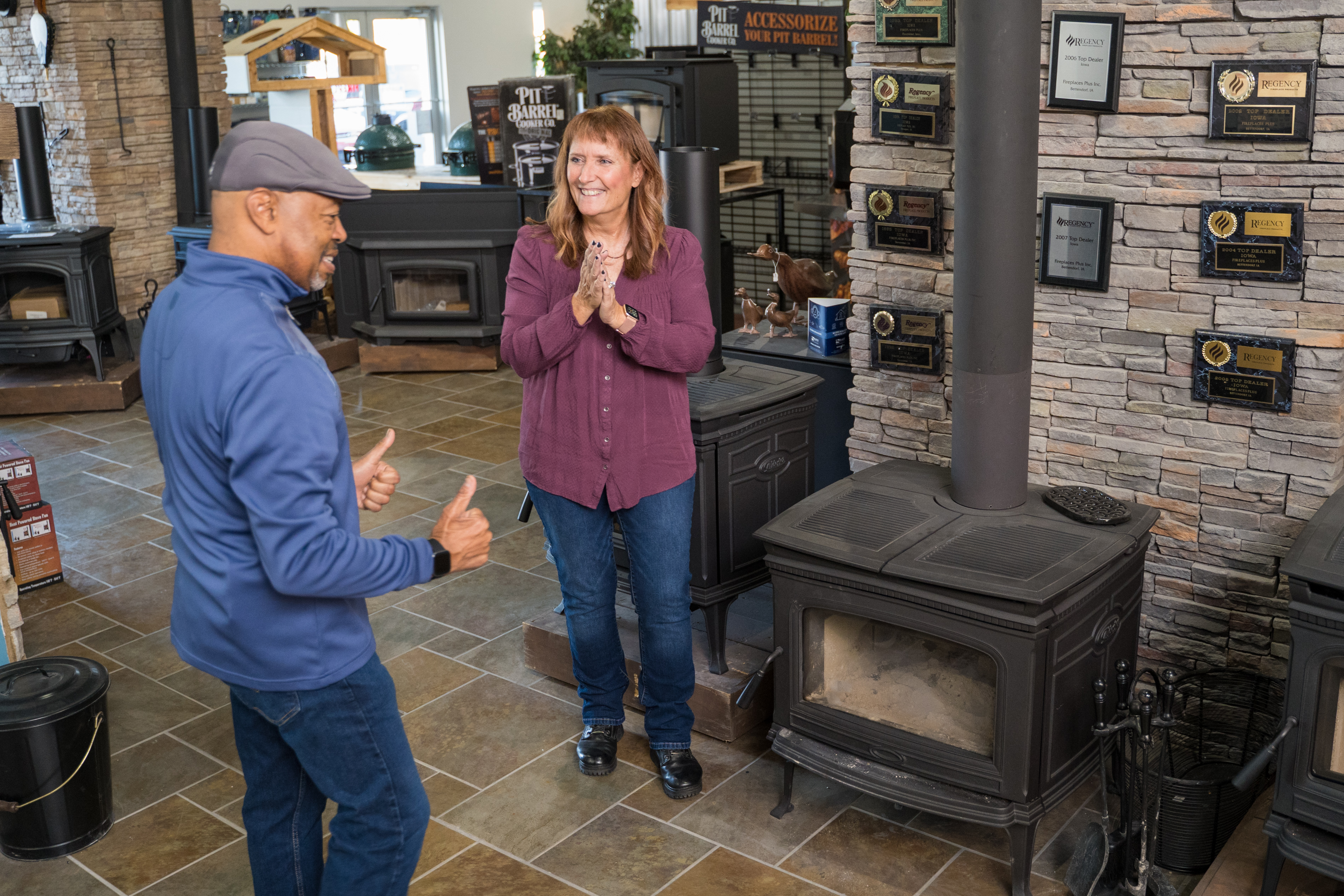 Excited couple shopping for a new fireplace from Fireplaces Plus in Downtown Bettendorf, IA